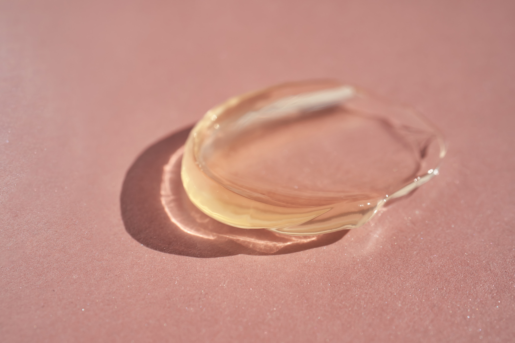 The texture of a yellow transparent gel cosmetic.